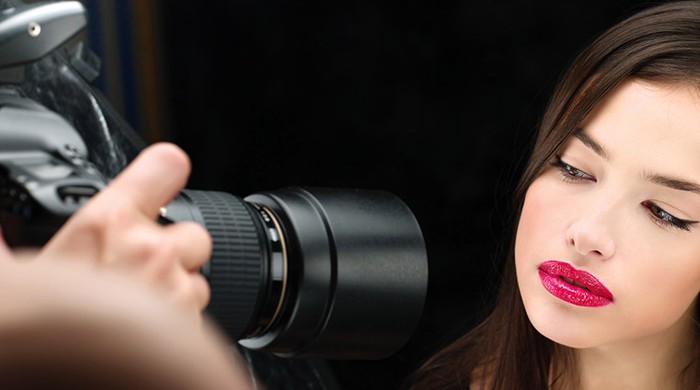 Pretty female model on photo shooting in studio